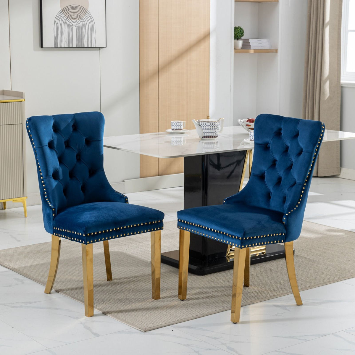 Nikki - Silla de comedor moderna y de alta gama, de madera maciza capitoné, tapizada en terciopelo, con patas de acero inoxidable dorado y ribete de tachuelas (juego de 2)
